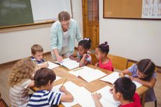 Teacher working with elementary school children.