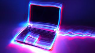 A laptop with outlines made from neon light