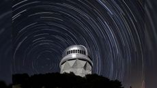 Star trails are seen over the Nicholas U. Mayall 4-meter Telescope on Kitt Peak National Observatory near Tucson, Arizona.