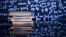 Collection of science books in front of a blackboard