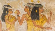 A painting of three ancient Egyptians wearing head cones