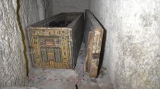 a coffin in a tomb with hieroglyphics