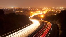 A long exposure photograph of traffic on a road at night in Toulouse, France.