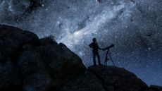 man with a telescope against a starry sky